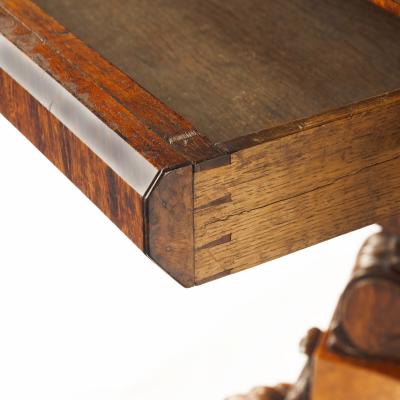 An unusual William IV amboyna and oak four drawer library table by Simpson