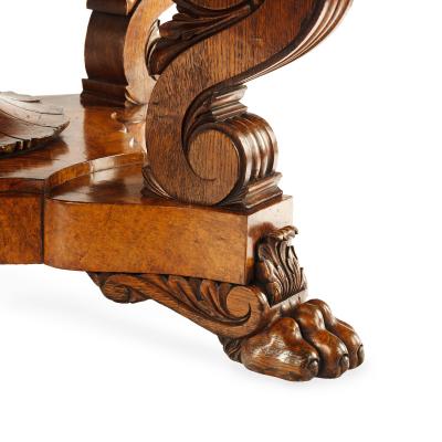 An unusual William IV amboyna and oak four drawer library table by Simpson