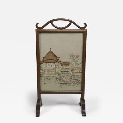 Anglo Japanese oak firescreen with a Torri gate detail embroidery river scene 