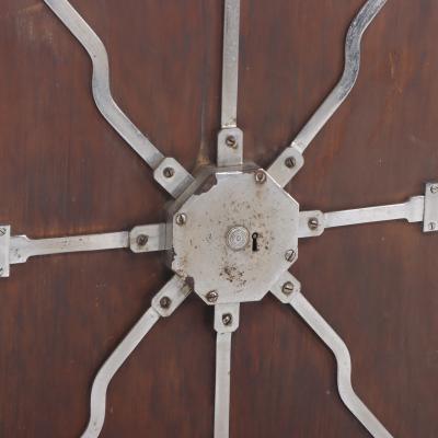 Antique steel lock mechanism mounted on a wooden board 