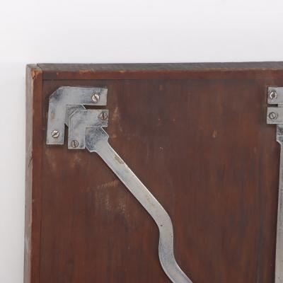 Antique steel lock mechanism mounted on a wooden board 