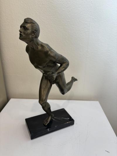 Art Deco bronze figure of a man wearing a loin cloth running