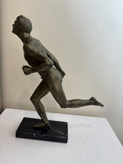 Art Deco bronze figure of a man wearing a loin cloth running