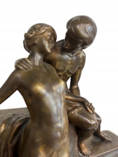 Art Deco bronze group of standing semi nude lady and seated man embracing