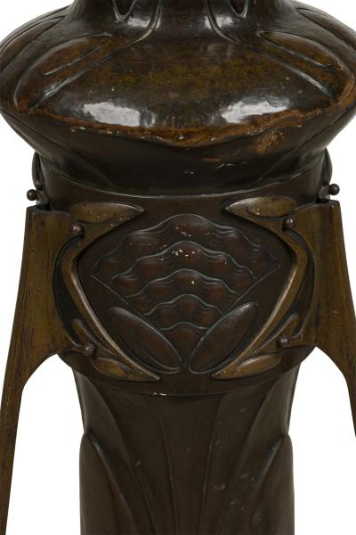 Art Nouveau bronze floor vase supported by 3 open design legs
