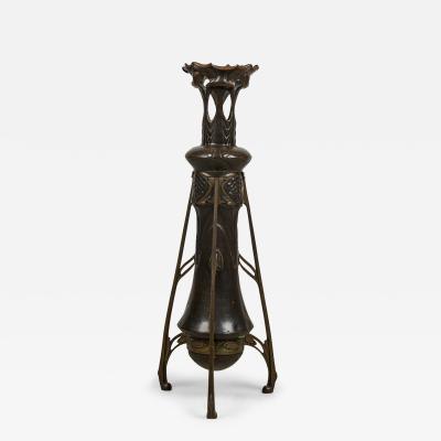 Art Nouveau bronze floor vase supported by 3 open design legs