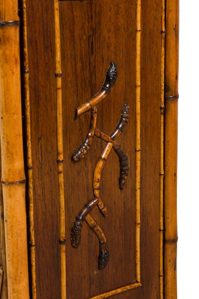 Bamboo 2 door cabinet with bone trim and side shelves and a back rail