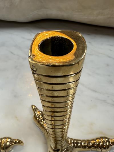 Brass candle holders designed in the shape of bird talons