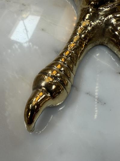 Brass candle holders designed in the shape of bird talons
