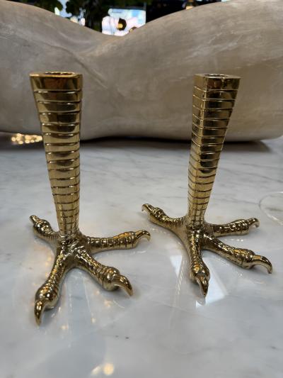 Brass candle holders designed in the shape of bird talons