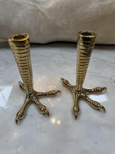 Brass candle holders designed in the shape of bird talons