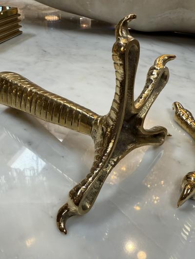 Brass candle holders designed in the shape of bird talons