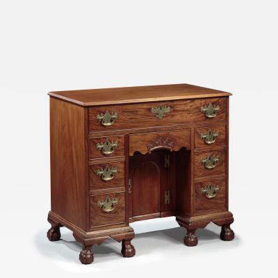 CHIPPENDALE KNEEHOLE DESK WITH BALL AND CLAW FEET AND A CARVED DRAWER