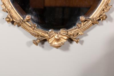 Carved French Giltwood Oval Mirror with Urn Crest Floral Garlands Circa 1870
