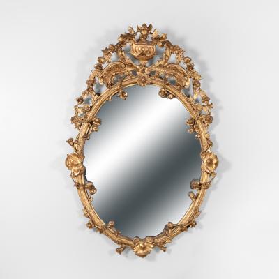 Carved French Giltwood Oval Mirror with Urn Crest Floral Garlands Circa 1870