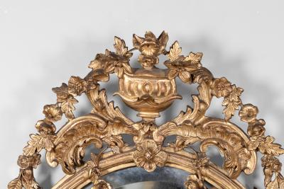 Carved French Giltwood Oval Mirror with Urn Crest Floral Garlands Circa 1870