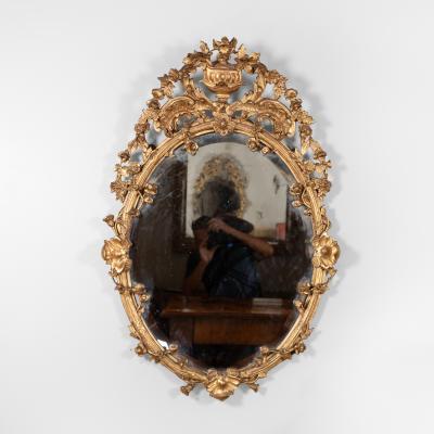 Carved French Giltwood Oval Mirror with Urn Crest Floral Garlands Circa 1870