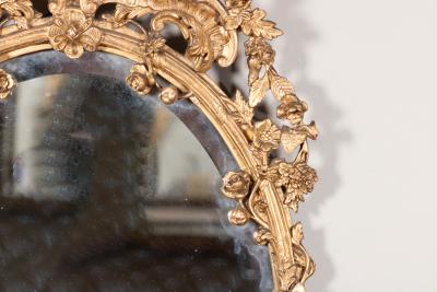 Carved French Giltwood Oval Mirror with Urn Crest Floral Garlands Circa 1870