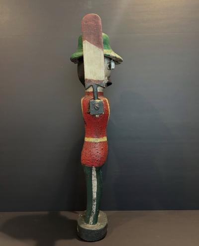 Carved and painted wood Whirligig of a soldier wearing red coat and a green hat 