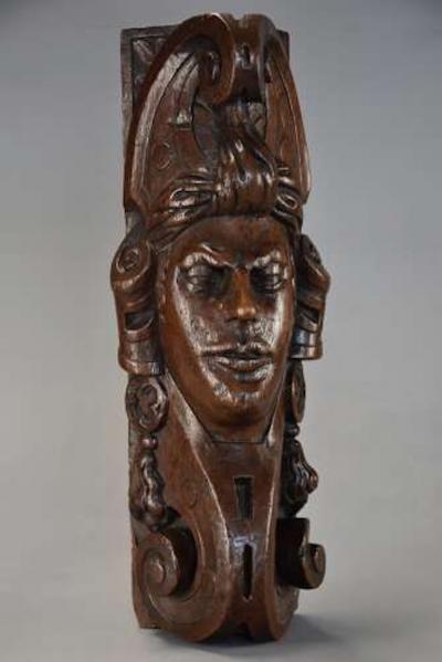 Carved oak corbel in the style of a Medieval man possibly Continental
