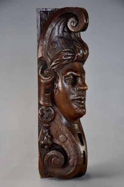 Carved oak corbel in the style of a Medieval man possibly Continental