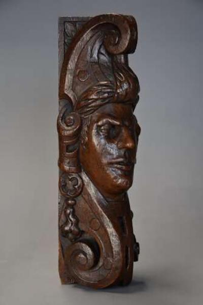 Carved oak corbel in the style of a Medieval man possibly Continental