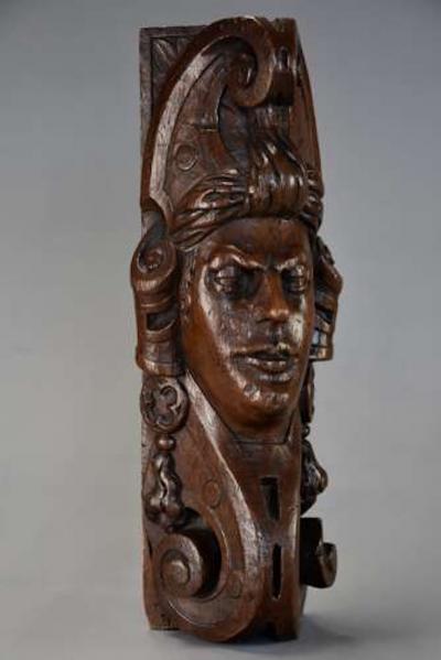 Carved oak corbel in the style of a Medieval man possibly Continental