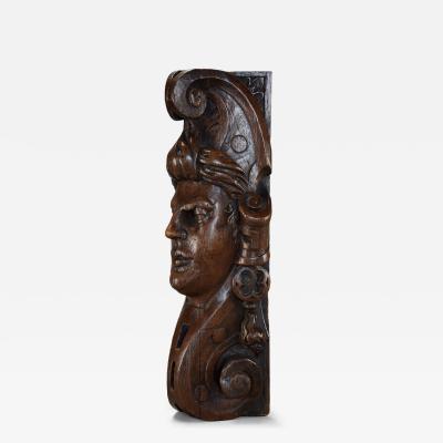 Carved oak corbel in the style of a Medieval man possibly Continental
