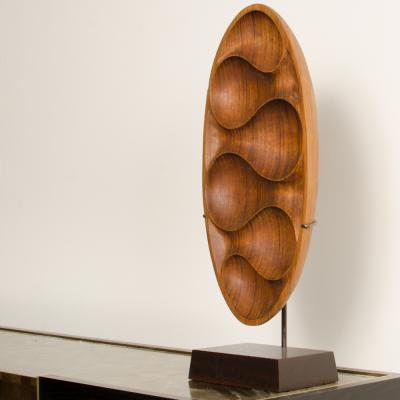 Carved wood almond shaped sculpture and base 