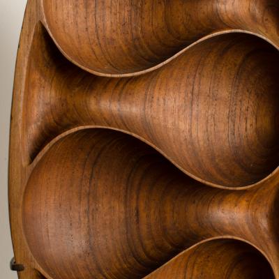Carved wood almond shaped sculpture and base 