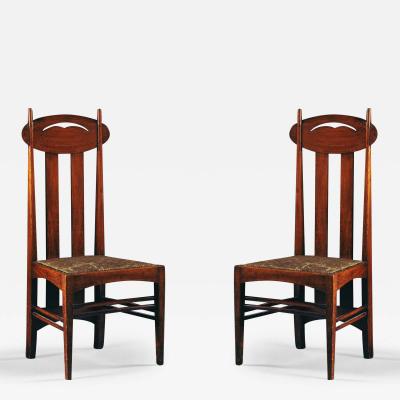 Charles Rennie Mackintosh A PAIR OF STAINED OAK DINING CHAIRS AFTER A DESIGN BY CHARLES RENNIE MACKINTOSH