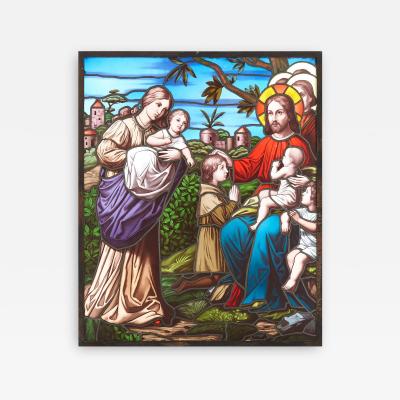 Christian stained glass window of Christ blessing children