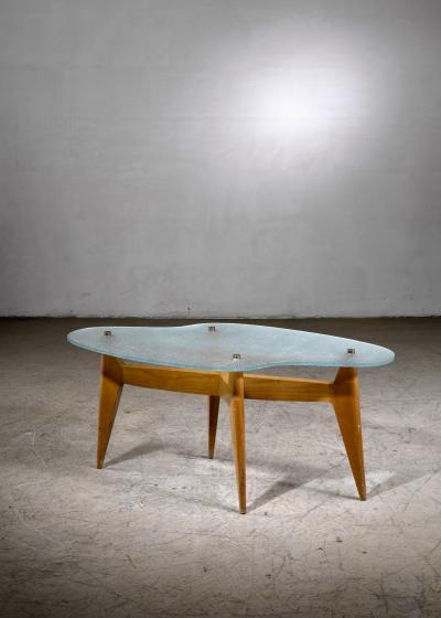Coffee table with free form glass top