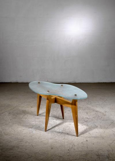 Coffee table with free form glass top