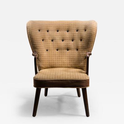 Curved lounge chair with yellow upholstery Sweden