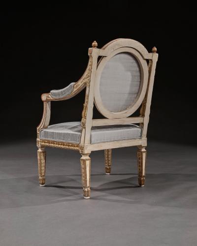 DECORATIVE ITALIAN PAINTED AND PARCEL GILT ARMCHAIRS OF NEO CLASSICAL DESIGN