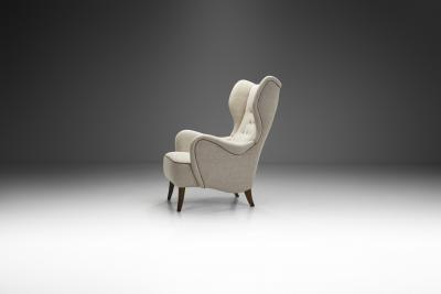 Danish Cabinetmaker Wing Back Chair with Stained Beech Legs Denmark 1940s