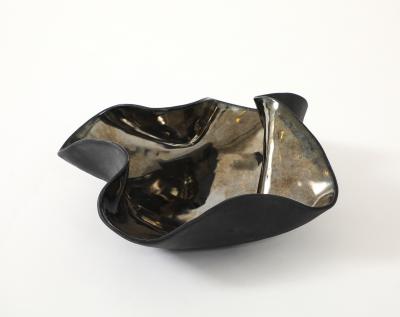 Decorative free form twist bowl in a highly reflective platinum finish