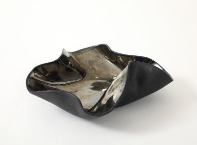 Decorative free form twist bowl in a highly reflective platinum finish