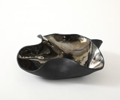 Decorative free form twist bowl in a highly reflective platinum finish