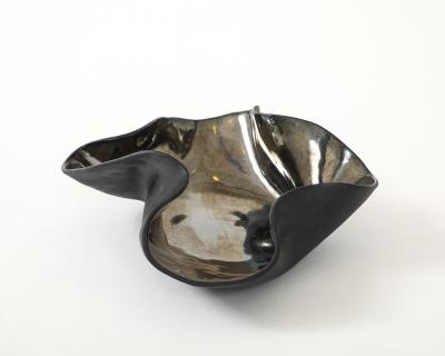 Decorative free form twist bowl in a highly reflective platinum finish