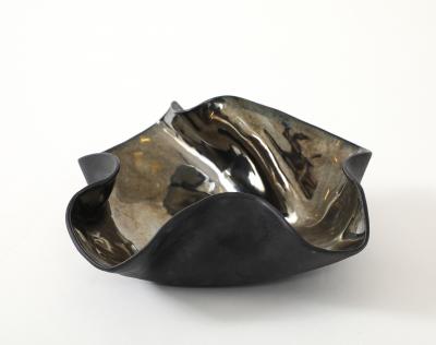 Decorative free form twist bowl in a highly reflective platinum finish