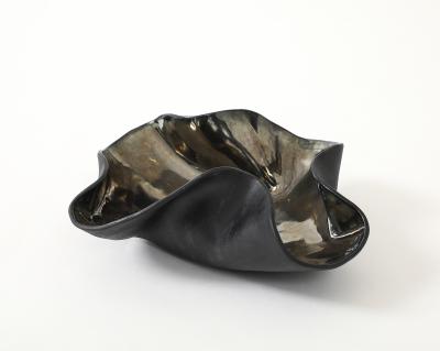 Decorative free form twist bowl in a highly reflective platinum finish