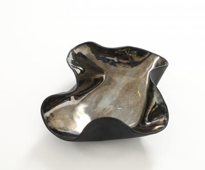 Decorative free form twist bowl in a highly reflective platinum finish