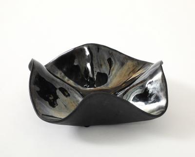 Decorative free form twist bowl in a highly reflective platinum finish 