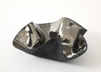 Decorative free form twist bowl in a highly reflective platinum finish