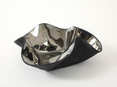 Decorative free form twist bowl in a highly reflective platinum finish