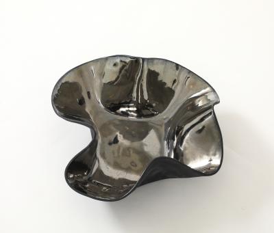 Decorative free form twist bowl in a highly reflective platinum finish