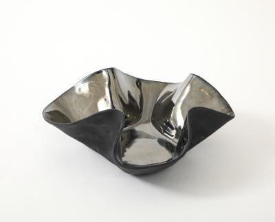 Decorative free form twist bowl in a highly reflective platinum finish