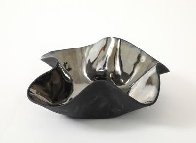 Decorative free form twist bowl in a highly reflective platinum finish